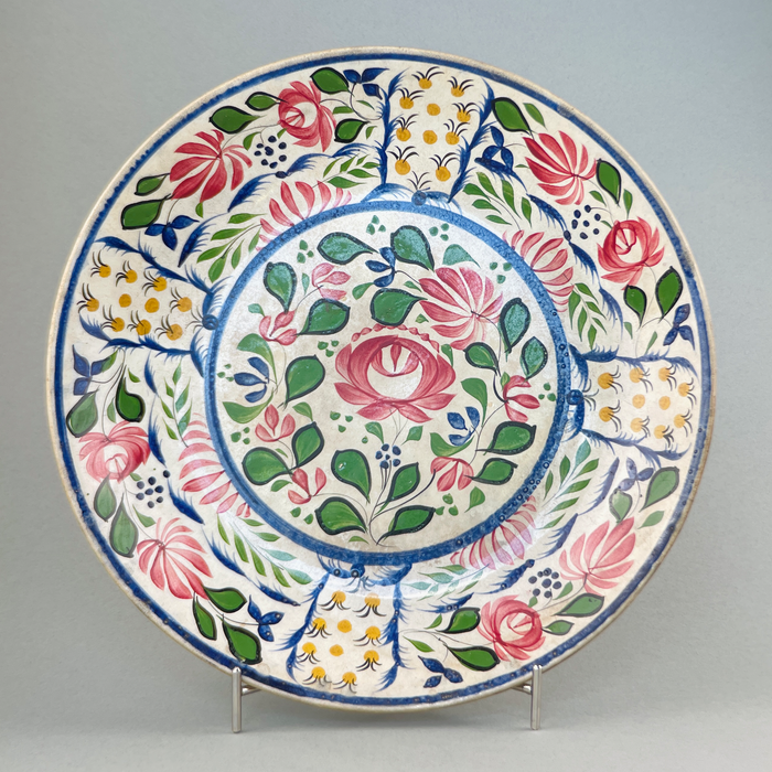 Front view of large antique English polychrome platter from the late Victorian era, featuring vibrant Arts and Crafts floral design.