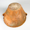Underside of the antique XL lebrillo bowl, revealing the unglazed terracotta body, broad circular foot and extensive age patina developed through long use. Wheel marks, scuffs, pale mineral deposits and natural tonal variation remain visible across the clay, confirming the handmade construction of this substantial Spanish pottery vessel.