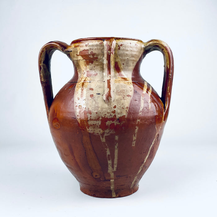 Wide mouth and interior of a traditional Spanish orza storage jar, with a dark brown glazed cavity, circular throwing rings and a naturally irregular rim. The nineteenth century terracotta vessel was made for domestic storage and now works as an antique pottery vase for dried branches, Mediterranean decor or wabi sabi decor.