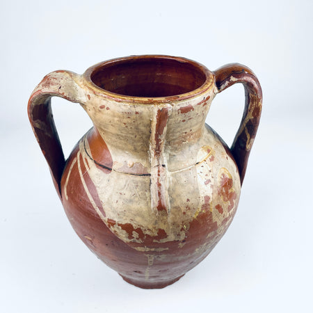 Traditional Spanish orza storage jar in glazed terracotta, with a broad open mouth and a dark honey brown glazed interior showing circular wheel marks from hand production. The nineteenth century Castilian pottery vessel has twin loop handles and a rounded body, making it a strong antique vase or sculptural jar for rustic home decor.
