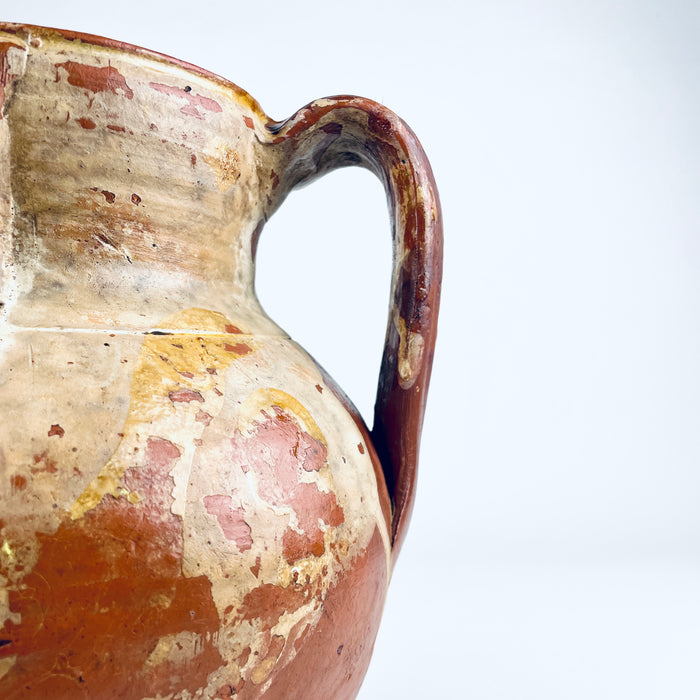 Surface detail of a nineteenth century Spanish terracotta vase showing glossy honey brown glaze, irregular glaze loss, exposed orange red clay and small firing marks. These authentic age related variations give the Castilian orza pottery jar a strong wabi sabi quality while preserving its clear identity as an antique Spanish storage vessel.