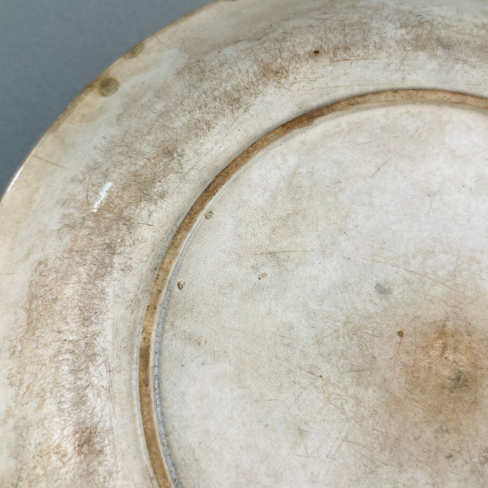 Back detail of English ceramic platter showing worn Victorian glaze and classic foot ring.