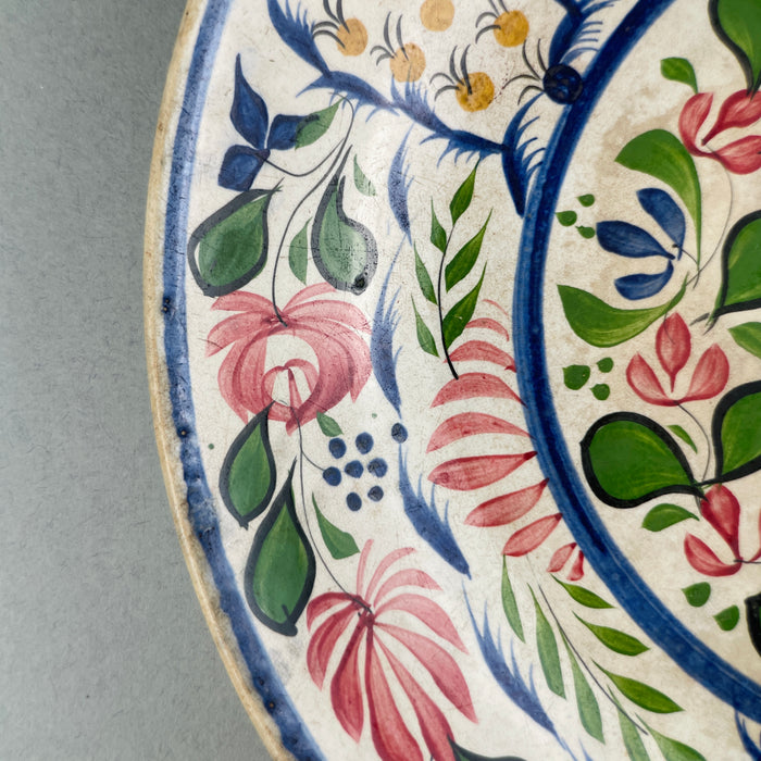 Close-up of intricate pineapple-inspired decorative panel on antique Victorian polychrome platter.