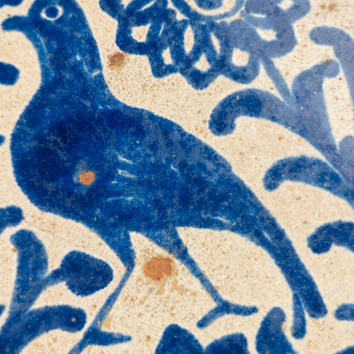 Interior glaze of the lebrillo bowl with visible signs of age including softened pigment, light crazing, and minor discoloration that enhance its historical character and authenticity as a 19th-century folk ceramic piece.