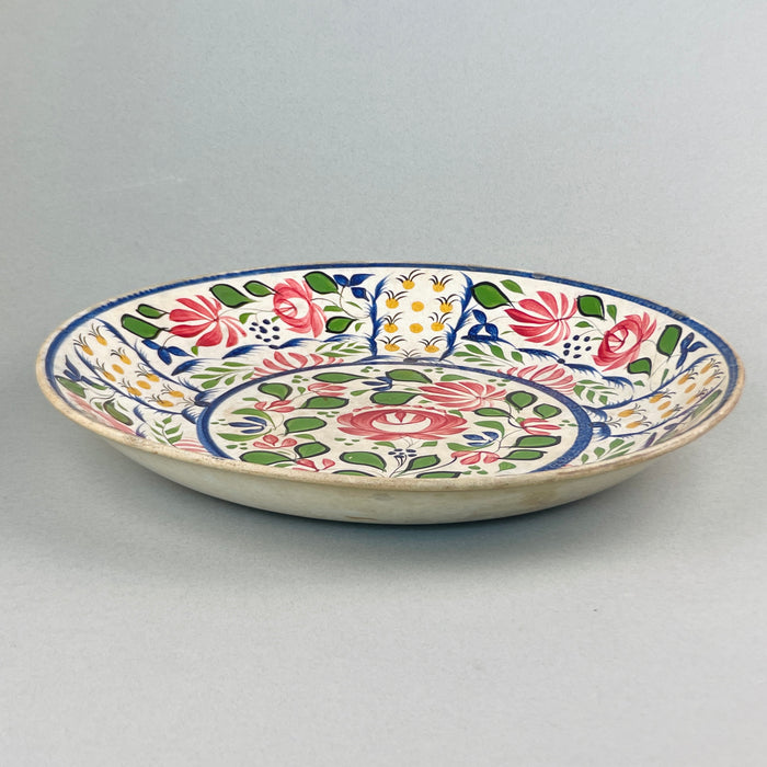 Rear view of late 19th-century English ceramic platter, showing aged glaze and unmarked foot rim with natural wear.