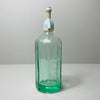 Rear angle of mid-century Spanish siphon bottle in green glass, showing clean fluted body lines and full silhouette of the antique metal siphon top with white lever detail.