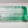 Transparent green vintage soda siphon glowing in studio light, showcasing fluted form, siphon mechanism, and rich Catalan provenance. Unique collector’s piece with visible embossed script and aged coloration on top, appealing to lovers of vintage European glass.