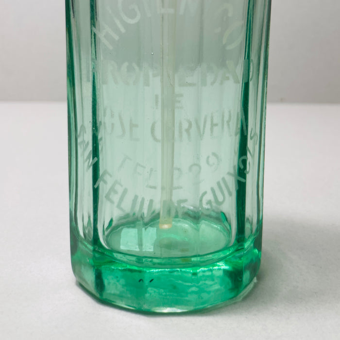 Close-up of etched lettering reading "SIFON HIGIÉNICO" and "JOSE CERVERA SAN FELIU DE GUIXOLS," showcasing authenticity and origin of this vintage Catalan soda siphon bottle. Light-filled image showcasing the clarity and thickness of vintage green soda glass and its etched typography from the 1950s.