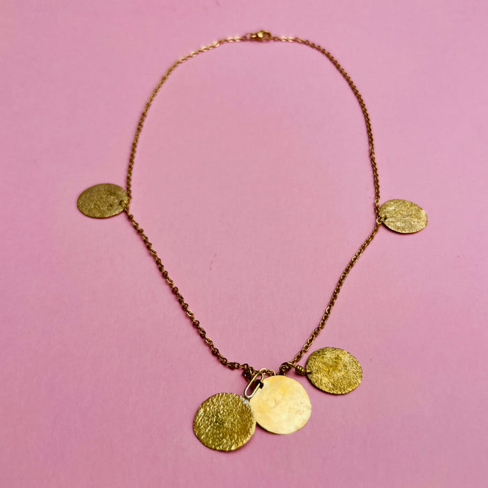 Aurelia Collection gold-tone necklace with hammered coin pendants on a fine link chain. Nickel free with spring-ring clasp, this 47.5 cm necklace reflects Mediterranean-inspired jewelry traditions with modern artisan detail. Lightweight at 7 g for versatile wear.
