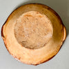 Base view of the antique tian, displaying its raw earthenware surface.