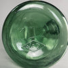 Close-up shot of bottle base with embossed diamond stamp and vintage number, indicating mid-century production.