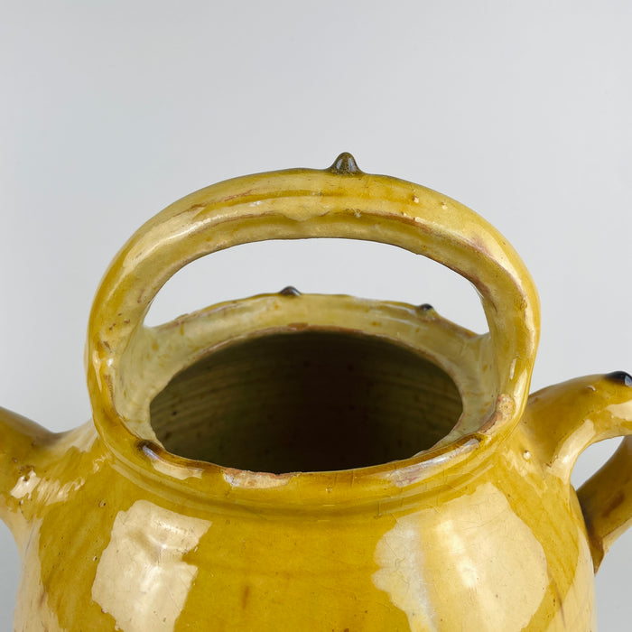 Top-down view of the terracotta gargolette pot, showing the opening and glaze depth. The handmade irregularities confirm its 19th century southern French origin. A strong fit for farmhouse decor, Mediterranean decor, and rustic home decor, adding visual warmth and artisan appeal to shelves or tabletops.
