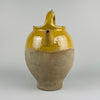 A close view of the early 20th century French terracotta gargolette reveals rich glaze variations, dripping glaze lines, and firing freckles typical of rural French pottery. The warm yellow glaze contrasts with the matte unglazed clay beneath. This antique vessel fits perfectly into farmhouse decor, rustic home decor, cottage decor, french country decor, and mediterranean decor, where genuine terracotta adds earthy texture and traditional craftsmanship.