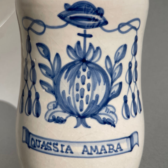 Talavera de la Reina ceramic apothecary jar, traditional Spanish majolica featuring vibrant cobalt blue detailing and a stylized botanical symbol referencing historic medicinal uses.