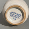 Ceramic apothecary jar from Talavera, featuring classic blue-and-white palette, ornate motif with religious and botanical symbolism, often found in 19th–20th century herbalist displays. Artisan-signed Talavera ceramic jar, underside stamp reading “La Menora Talavera España,” confirming its Spanish origin and hand-painted craftsmanship typical of the Talavera de la Reina region.