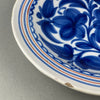 Manises or Talavera blue floral charger, shown flat from a top-down view, showcasing traditional Spanish brushwork and folk art decoration.