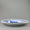 Vintage Spanish charger, close-up of the border area with scalloped detailing and orange concentric lines, traditional to mid-century Spanish pottery.