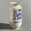 Spanish majolica pharmacy jar, hand-painted with pomegranate fruit and foliage, inscribed “Quassia Amara,” referencing the bitter medicinal plant once used in tonic preparations.