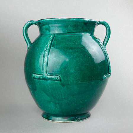Full profile view of antique French gargoulette featuring upward spout, looped side handles, and rare green-glazed surface, set against a neutral background to showcase the classic rustic silhouette.