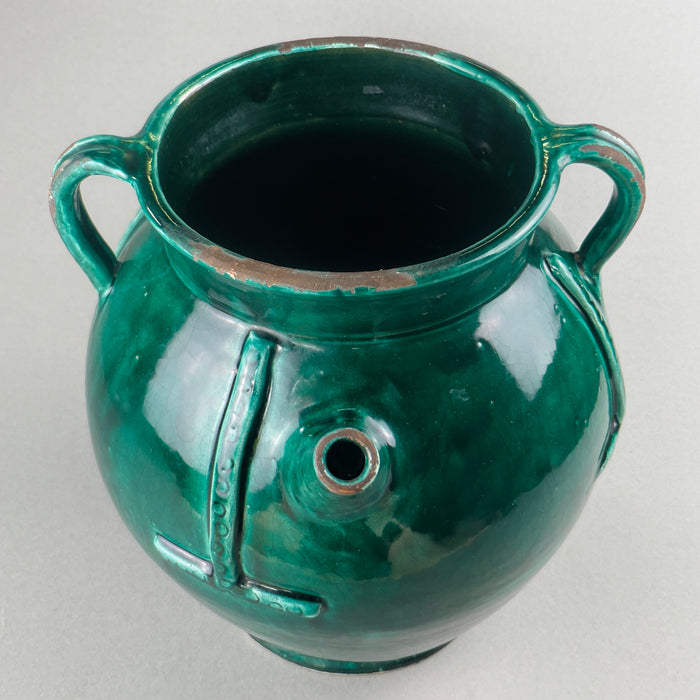 Close-up view of green-glazed surface with relief bands and subtle texture variation on the French gargoulette, highlighting the handmade quality and rich saturation of the glaze.
