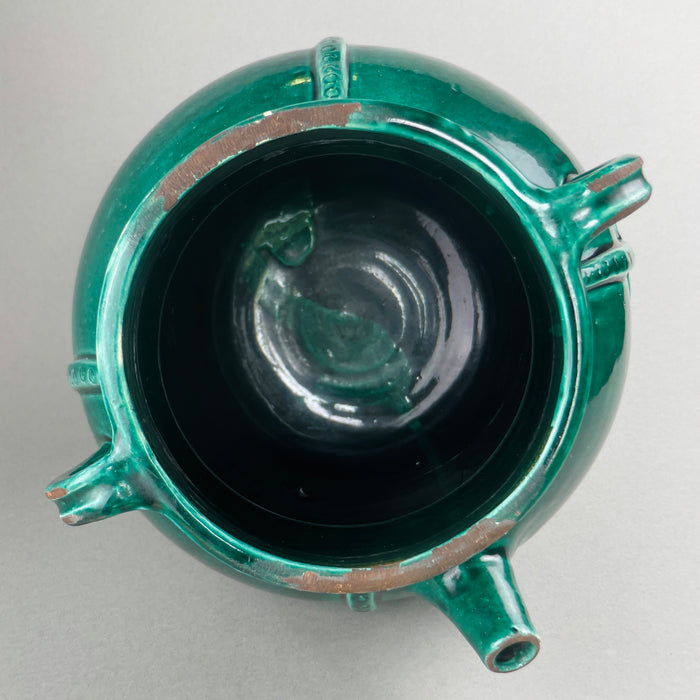 Detail view of one of the side handles, showing its hand-attached construction, glaze pooling, and minor irregularities that contribute to the piece’s authenticity and visual charm.