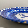 

Rear view of the ceramic plate showing signs of age, kiln marks, and a white glazed surface with minor blue remnants, supporting its historical authenticity.