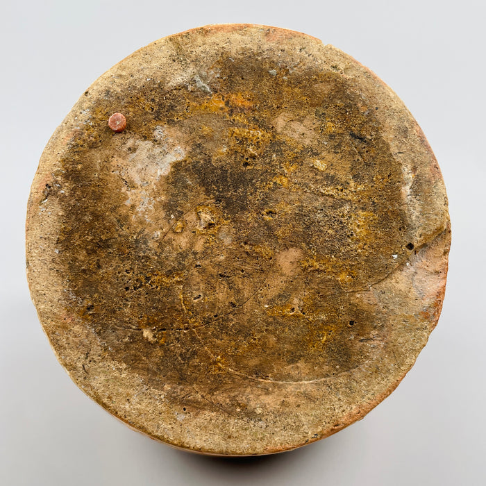 Underside image of French water jug with raw, unglazed terracotta base showing textured surface wear and firing marks, indicative of handmade production, often sought after for authentic wabi-sabi or rural European decor.