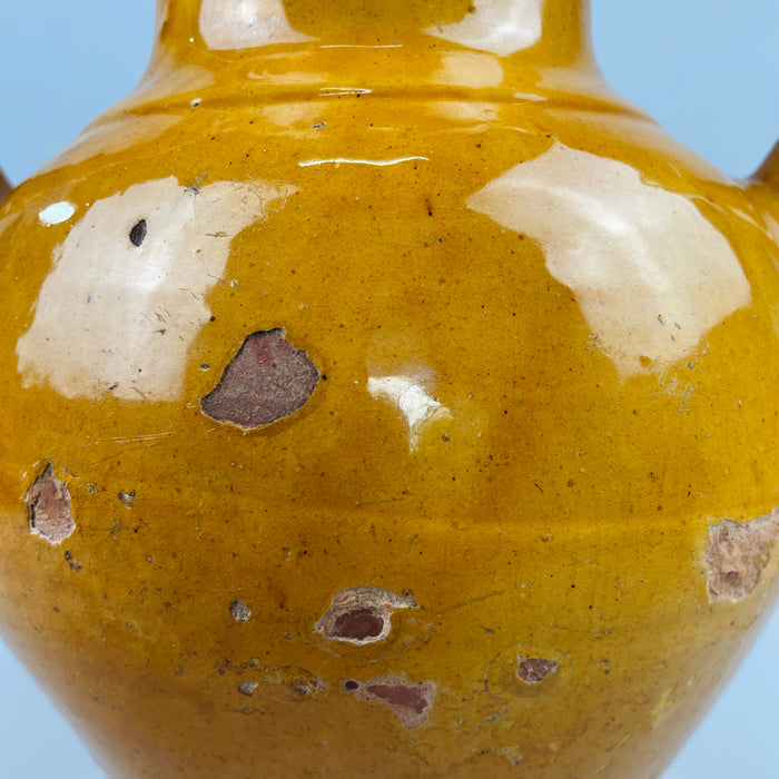 Full product image of antique glazed French jug with classic form and ochre glaze, presented against a neutral background to emphasize silhouette and color, perfect for online catalog use or vintage ceramic product listings.