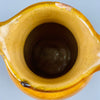 Interior top view showing terracotta jug’s circular opening and glazed interior, demonstrating its past utilitarian use and highlighting its appeal as a decorative object for dried arrangements or as a stand-alone sculptural piece.