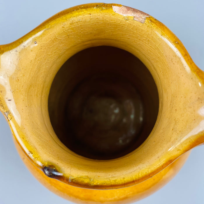 Interior top view showing terracotta jug’s circular opening and glazed interior, demonstrating its past utilitarian use and highlighting its appeal as a decorative object for dried arrangements or as a stand-alone sculptural piece.