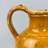 Rear angled view showing full height and width of the antique jug, with rounded body, elegant proportions, and aged glaze texture, suitable as a visual highlight in traditional or rustic French country design schemes.