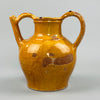 Side view of antique terracotta gargoulette with worn yellow glaze and bulbous form, showcasing traditional utilitarian pottery from Southwest France, perfect for use in rustic interiors, garden rooms, or farmhouse decor collections.