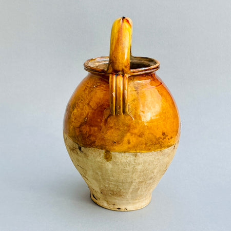 French farmhouse decor – vintage pottery water jug in warm ochre glaze.