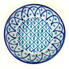 Large Spanish Fajalauza lebrillo bowl from Granada pottery tradition, hand painted in cobalt blue and green on a cream-white glazed earthenware surface. The deep ceramic bowl has a lattice center, vegetal motifs, blue arched border, and pierced hanging hole for wall display in Mediterranean decor or Spanish farmhouse decor.