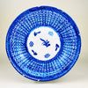 Antique Spanish majolica plate from Manises, Valencia, signed and hand painted in cobalt blue over a white tin glazed earthenware ground. The large charger has a dense crosshatched lattice across the broad sloping rim, braided blue borders, and a central reserve with stylized botanical and grid motifs, making it distinctive ceramic wall art for Mediterranean decor.