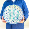 Blue green Fajalauza bowl with hand painted Granada pottery decoration, combining a bold cobalt rim, geometric lattice center, and repeated green brush marks. The large ceramic bowl is designed for wall display or tabletop styling and works well with rustic home decor, vintage kitchen decor, and Mediterranean ceramic collections.