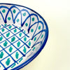 Large Granada lebrillo bowl in hand painted ceramic, made with a cream glazed ground, blue lattice decoration, green motifs, and a repeated arched border around the inner wall. The bowl can be displayed upright using the pierced hanging hole or styled flat as a table centerpiece for Mediterranean decor and Spanish farmhouse decor.