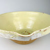 Antique French terracotta tian bowl, showing the softly mottled pale yellow glaze, fine speckling, subtle blue-green flecks, and wheel-thrown ridges beneath the finish. These handmade variations and time-softened surface are characteristic of rustic provincial pottery and complement wabi sabi decor and Mediterranean decor.