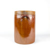 Brown glazed French confit pot dating to the early 20th century, made from dense stoneware with wheel-thrown rings, a broad opening, two pierced ear handles, and its fitted lid. Natural firing variation, minor glaze losses, scratches, and patina document its former household use. This antique crock adds authentic texture to farmhouse decor, wabi sabi decor, and vintage kitchen settings.