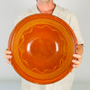 Large antique French tian bowl formed from wheel thrown terracotta, with a warm reddish brown glazed interior and repeated yellow lines following the curve of the bowl. The broad opening, substantial rolled rim, and earthy exterior give this Southern French pottery strong presence as a decorative bowl, fruit bowl, or rustic table centerpiece.