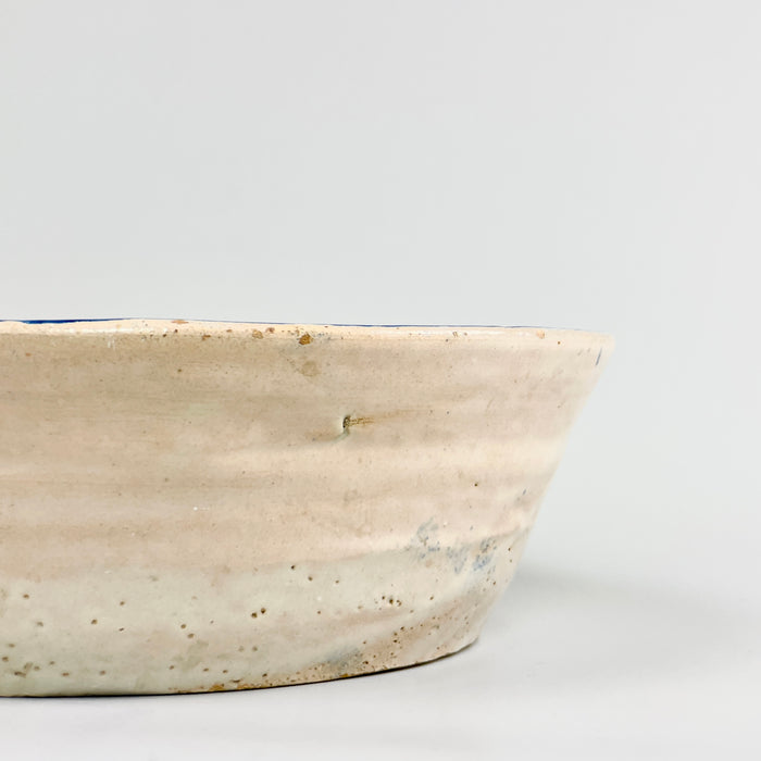 Profile view of the 9 cm tall Fajalauza bowl highlighting the flared form, subtly warped rim, and natural irregularities of its wheel-thrown structure, emblematic of handcrafted 19th-century Andalusian ceramic practices.