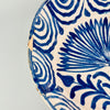 Full angled view of the bowl placed flat on a neutral surface, revealing both the dimensional depth of the vessel and its decorative utility as a display bowl or centerpiece in a Mediterranean-themed home.