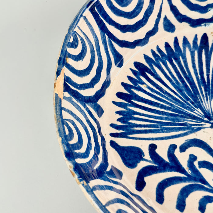 Full angled view of the bowl placed flat on a neutral surface, revealing both the dimensional depth of the vessel and its decorative utility as a display bowl or centerpiece in a Mediterranean-themed home.