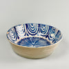 Full top-down view of a 19th-century Spanish ceramic bowl with traditional hand-painted cobalt palm tree and wave decorations, wheel-thrown from earthenware and finished with white glaze, embodying the regional folk artistry of Granada.