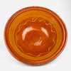Rich orange and honey brown glaze fills the deep interior of this XL antique French terracotta tian bowl, framed by yellow concentric lines and an expressive wavy motif. The generous open form, handmade irregularities, and aged surface make it a strong decorative bowl for farmhouse decor, rustic home decor, or Mediterranean decor.