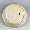Backside of antique Spanish lebrillo showcasing the unglazed terracotta base with subtle wheel rings and aged firing marks, highlighting its hand-thrown craftsmanship and authentic Andalusian origins from the 1800s.