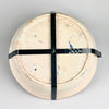 The rear of the ceramic bowl fitted with a cross-shaped black metal wall mount, allowing the 19th-century Fajalauza lebrillo to be displayed vertically as a decorative element in Mediterranean or rustic interiors.
