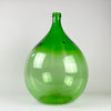 Vintage French demijohn made from richly colored emerald-green glass, with a substantial rounded body, sloping shoulders, narrow neck, and thick reinforced rim. Originally used as a large wine carboy, the 25 L vessel can now be displayed empty or used as a branch vase beside a console, fireplace, staircase, or large window.