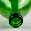 Vintage French wine carboy in deep emerald-green glass, shown as an oversized decorative demijohn with a substantial bulbous body and narrow reinforced neck. The vessel was traditionally intended for storing or transporting wine, cider, or homemade spirits and now works as a floor vase or freestanding sculptural glass object.
