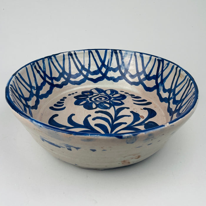 19th century Spanish ceramic lebrillo, with tin glaze and hand painted cobalt motifs, includes original pierced holes for hanging, ideal as Vintage Kitchen wall decor, Mediterranean Decor, Rustic Home Decor, Coastal decor, Cottage Decor, Japandi inspired styling or wabi sabi ceramic displays in French country decor and farmhouse settings.